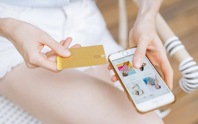  Seamless mobile eCommerce experience as a shopper browses an online store on their smartphone while holding a credit card.